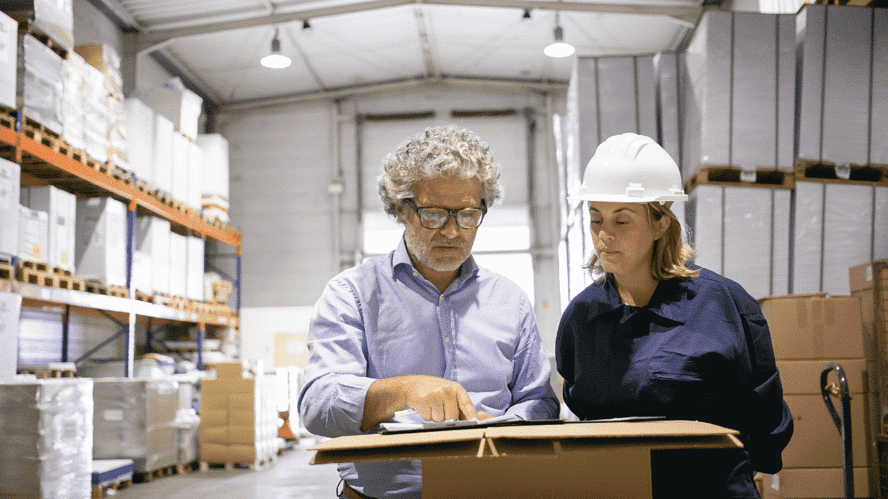 Manager and employee consultation in factory workplace